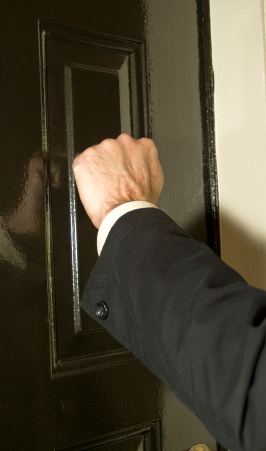 Hand knocking on door