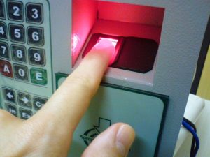 User placing finger on fingerprint scanner